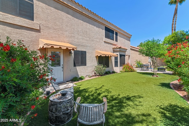 67 W Sarah Ln, Tempe, AZ 85284 - back of property with stucco siding, a yard, a tiled roof, and a patio