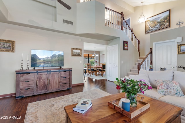 67 W Sarah Ln, Tempe, AZ 85284 - living room featuring dark wood-type flooring, stairway, baseboards, and a towering ceiling
