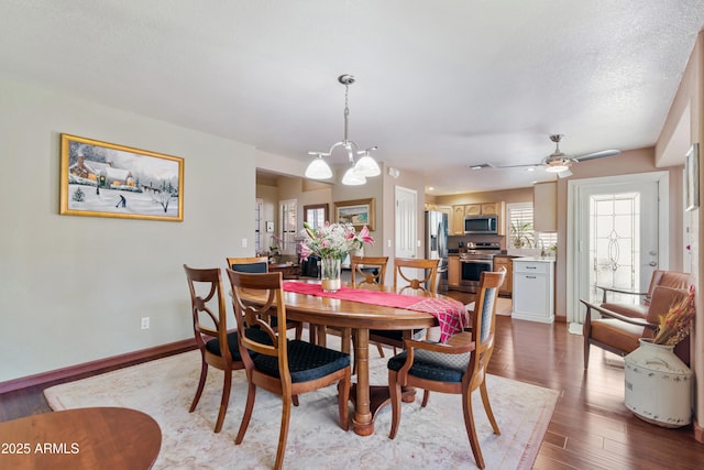 67 W Sarah Ln, Tempe, AZ 85284 - dining area with a chandelier, wood finished floors, baseboards, and ceiling fan