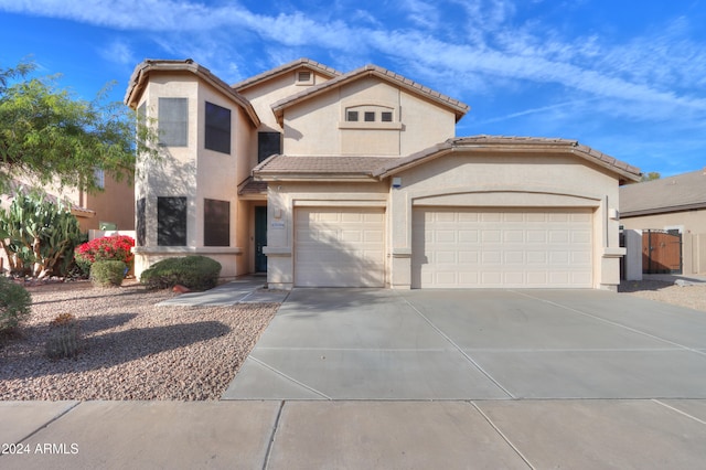 view of front of house featuring a tile roof, concrete driveway, and stucco siding