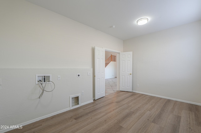 laundry area with hookup for an electric dryer, hookup for a washing machine, and light hardwood / wood-style floors