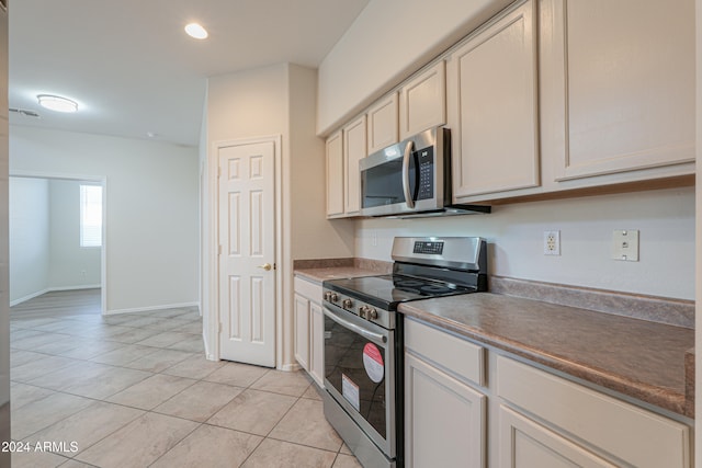 kitchen featuring appliances with stainless steel finishes and light tile patterned floors