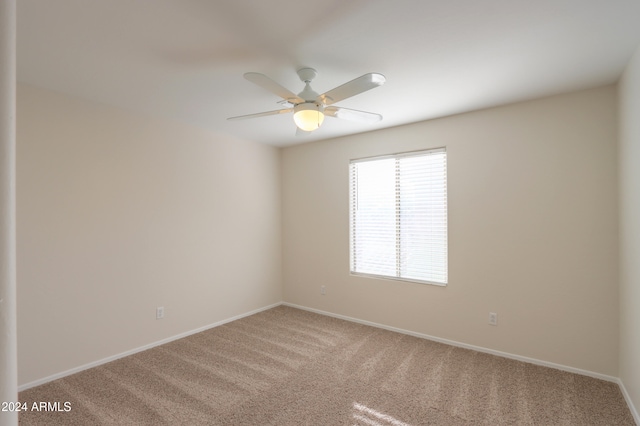 empty room featuring carpet flooring and ceiling fan