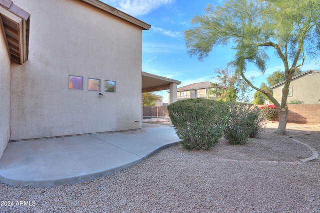 view of side of home with a patio