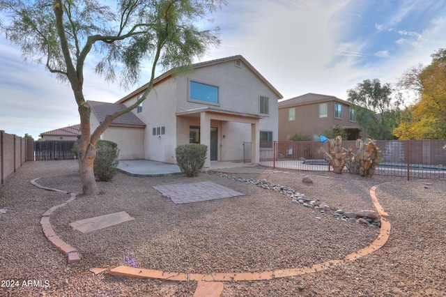 back of property with a patio area and a pool