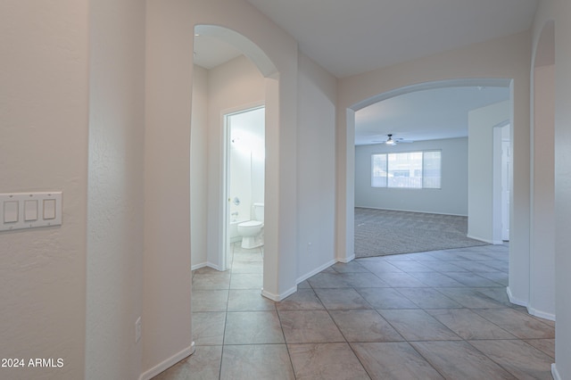 corridor featuring light colored carpet