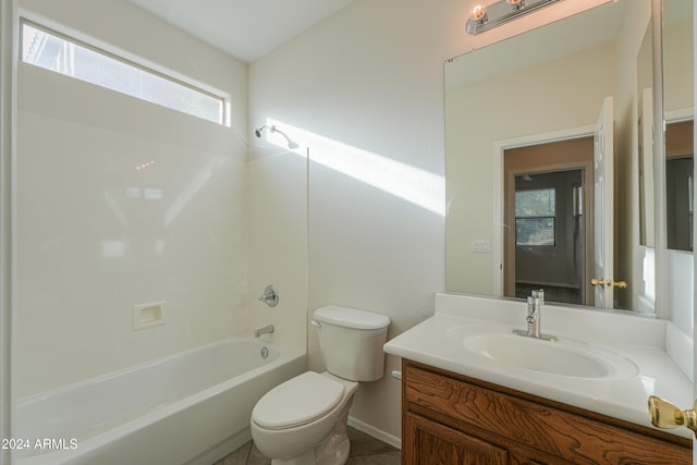 full bathroom featuring washtub / shower combination, vanity, and toilet