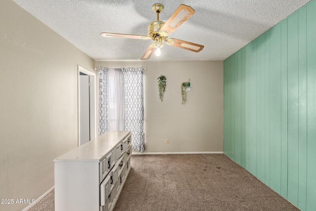 4624 S Fair Ln, Tempe, AZ 85282 - empty room with carpet floors, a textured ceiling, a ceiling fan, and wooden walls