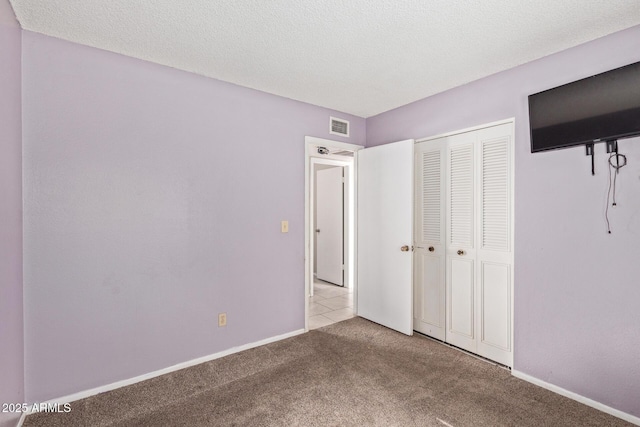 4624 S Fair Ln, Tempe, AZ 85282 - unfurnished bedroom with carpet, a closet, baseboards, and a textured ceiling