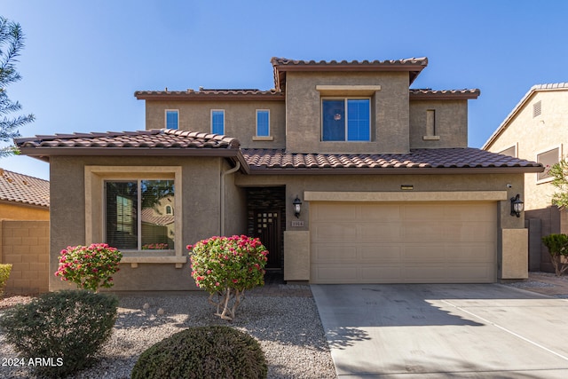 mediterranean / spanish-style house with a garage