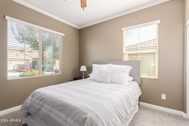 bedroom featuring ceiling fan, ornamental molding, and light colored carpet