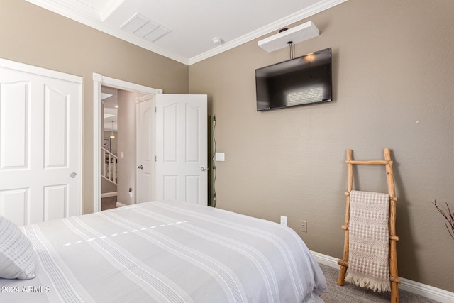 bedroom featuring a closet, carpet flooring, and ornamental molding