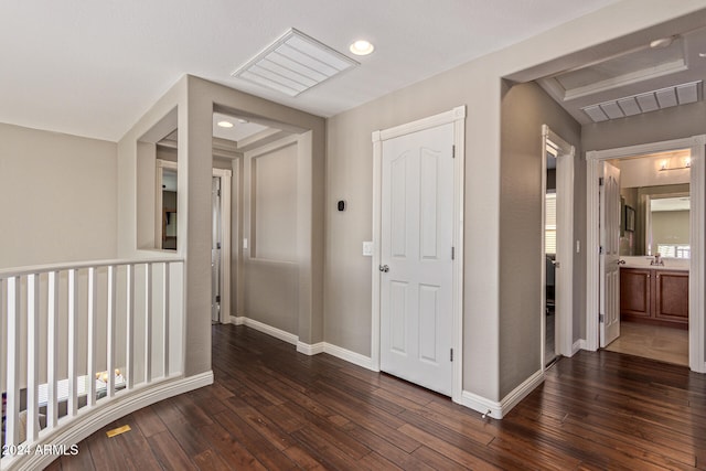 hallway with dark wood-type flooring and sink