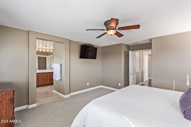 carpeted bedroom featuring ceiling fan and ensuite bathroom