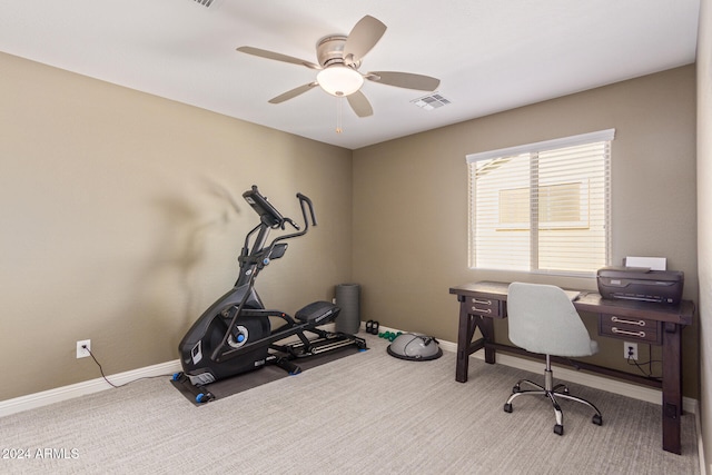 carpeted office space featuring ceiling fan