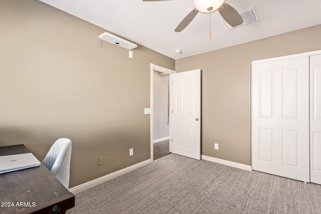 unfurnished office featuring carpet and ceiling fan