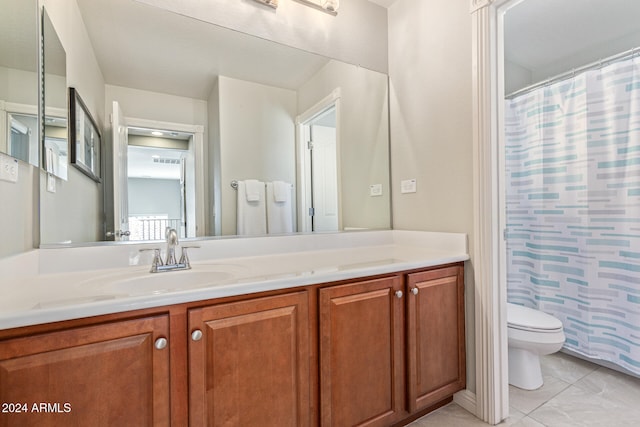 bathroom featuring a shower with shower curtain, tile patterned flooring, vanity, and toilet