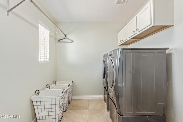 laundry room with cabinets and washer and dryer