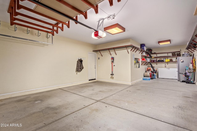 garage with stainless steel refrigerator and a garage door opener