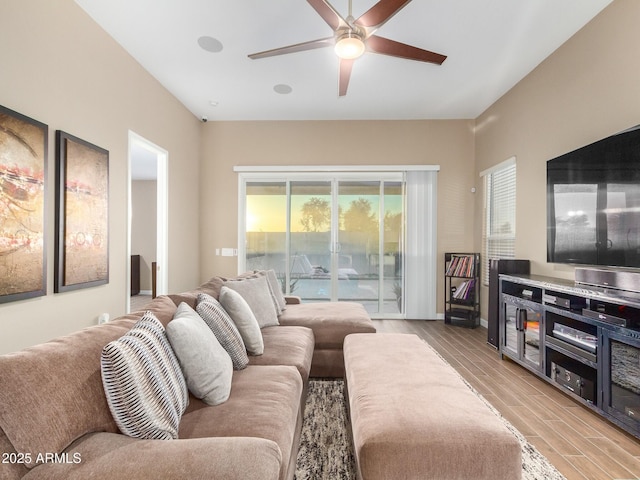 living room featuring light hardwood / wood-style floors and ceiling fan