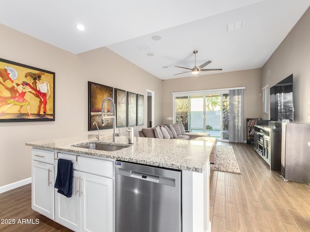 kitchen featuring white cabinetry, light hardwood / wood-style floors, stainless steel dishwasher, and sink