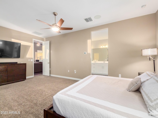 carpeted bedroom with ceiling fan and ensuite bathroom