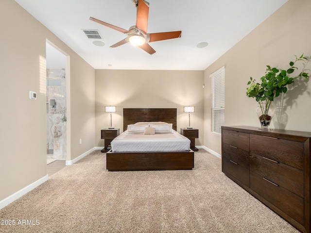 carpeted bedroom featuring ceiling fan and ensuite bath