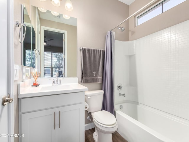 full bathroom with toilet, shower / bathtub combination with curtain, hardwood / wood-style flooring, and vanity