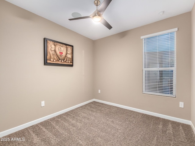 spare room featuring ceiling fan and carpet flooring