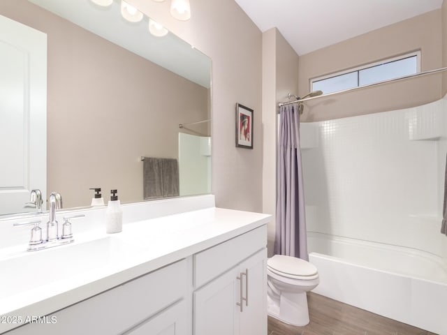 full bathroom with hardwood / wood-style floors, toilet, vanity, and shower / tub combo with curtain