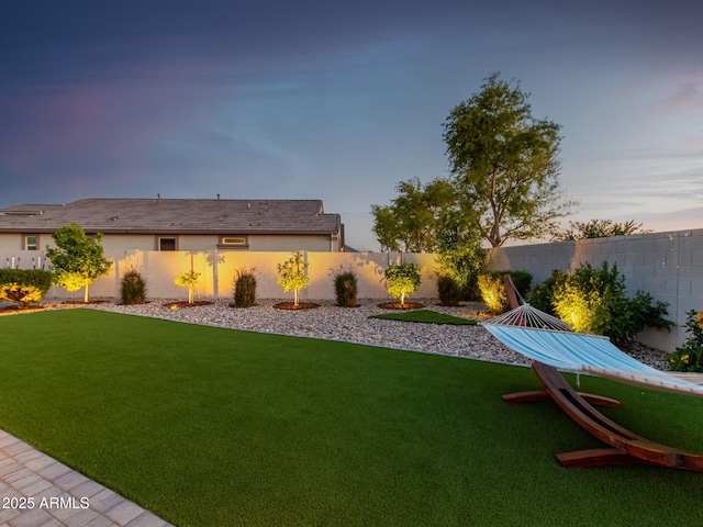 view of yard at dusk