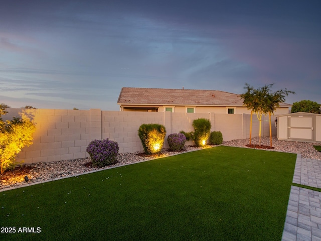 exterior space with a lawn and a storage shed