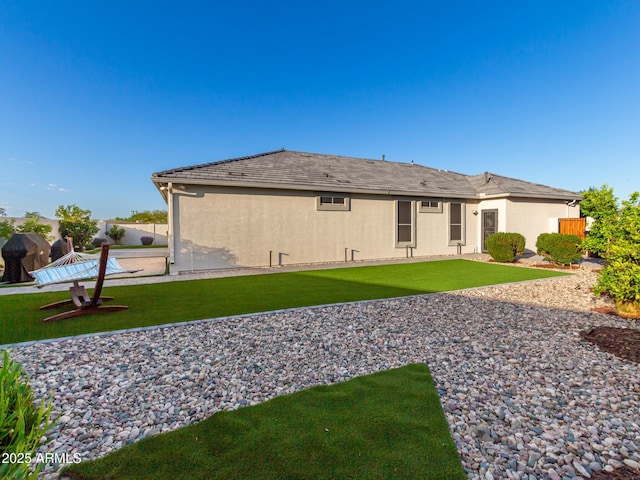 back of house with a lawn