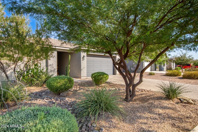 obstructed view of property with a garage