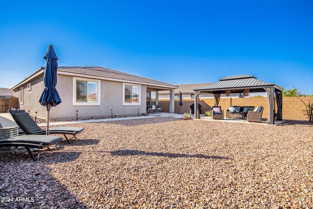 back of house featuring a gazebo and a patio area