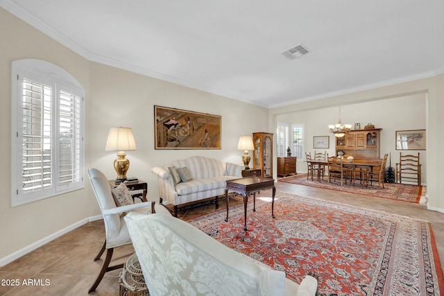 living room featuring tile patterned flooring, crown molding, and an inviting chandelier