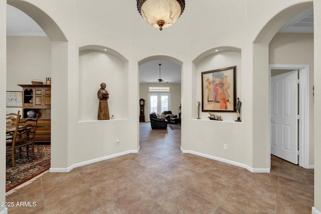 corridor featuring french doors and ornamental molding