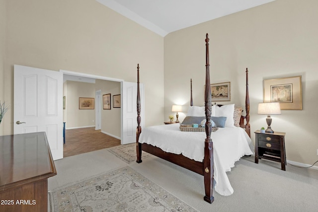 carpeted bedroom featuring high vaulted ceiling