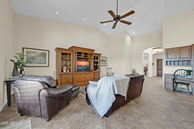 living room featuring ceiling fan, high vaulted ceiling, and light tile patterned floors