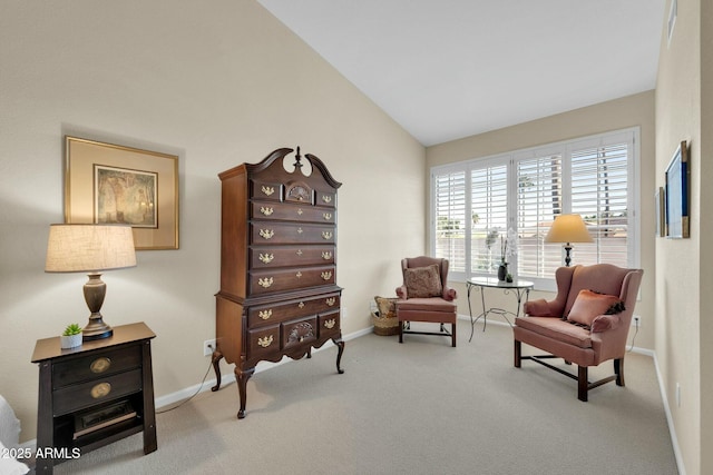 living area featuring carpet floors and lofted ceiling