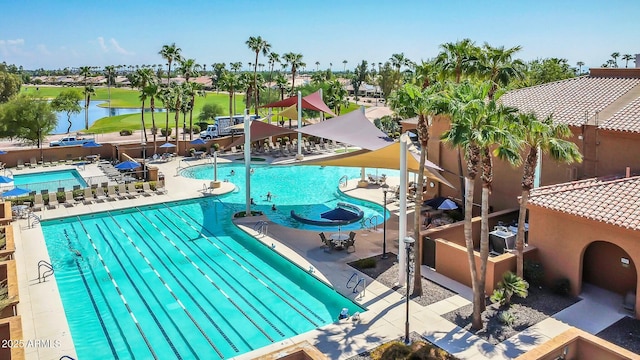 view of swimming pool featuring a patio area and a water view