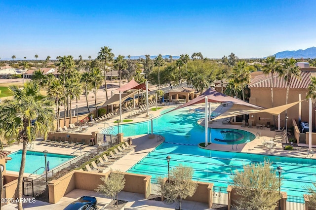 view of swimming pool featuring a mountain view and a patio area