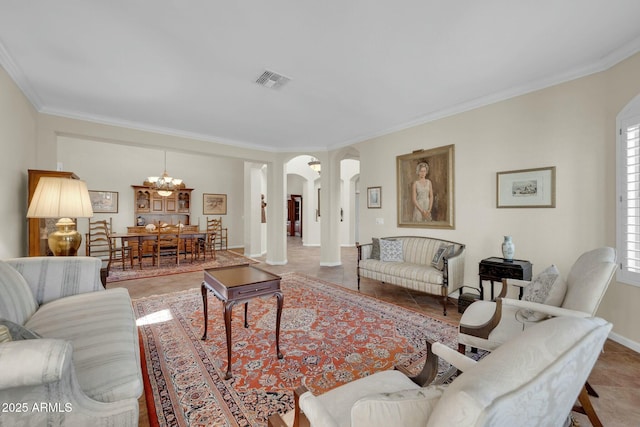 living room with tile patterned floors, an inviting chandelier, and ornamental molding