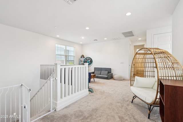 living area with an upstairs landing, carpet flooring, and recessed lighting