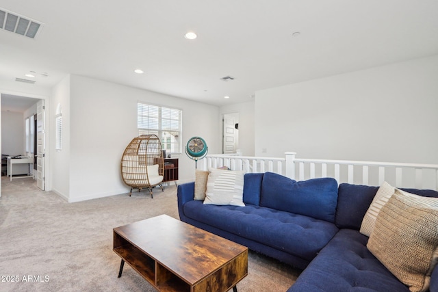 living area with light carpet, recessed lighting, and baseboards