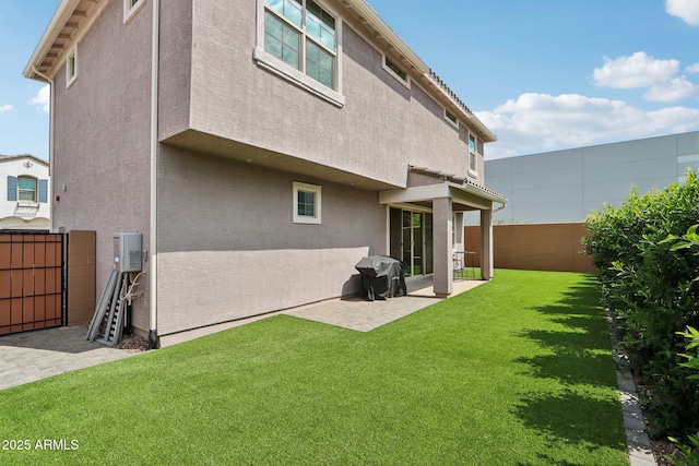 rear view of house featuring a patio and stucco siding