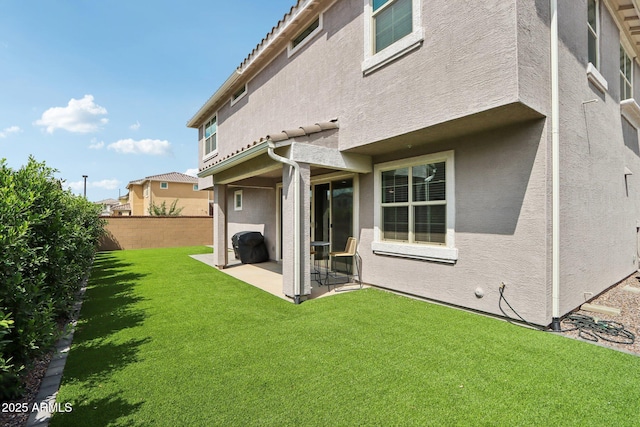 back of house featuring stucco siding and a patio area