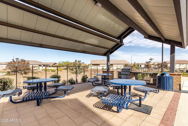 view of patio / terrace featuring outdoor dining space, a residential view, and grilling area