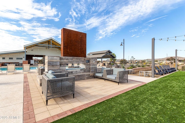 view of patio / terrace featuring a gazebo, an outdoor pool, exterior kitchen, and outdoor lounge area