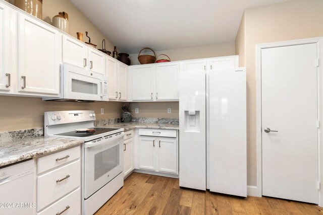 kitchen featuring light stone counters, white cabinets, white appliances, and light wood-type flooring